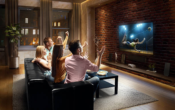 istock Couples watching Volleyball game at home 635990404