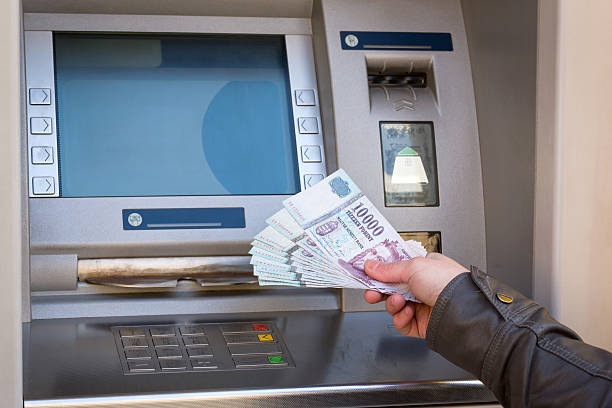istock woman hand showing banknotes at ATM 635992522