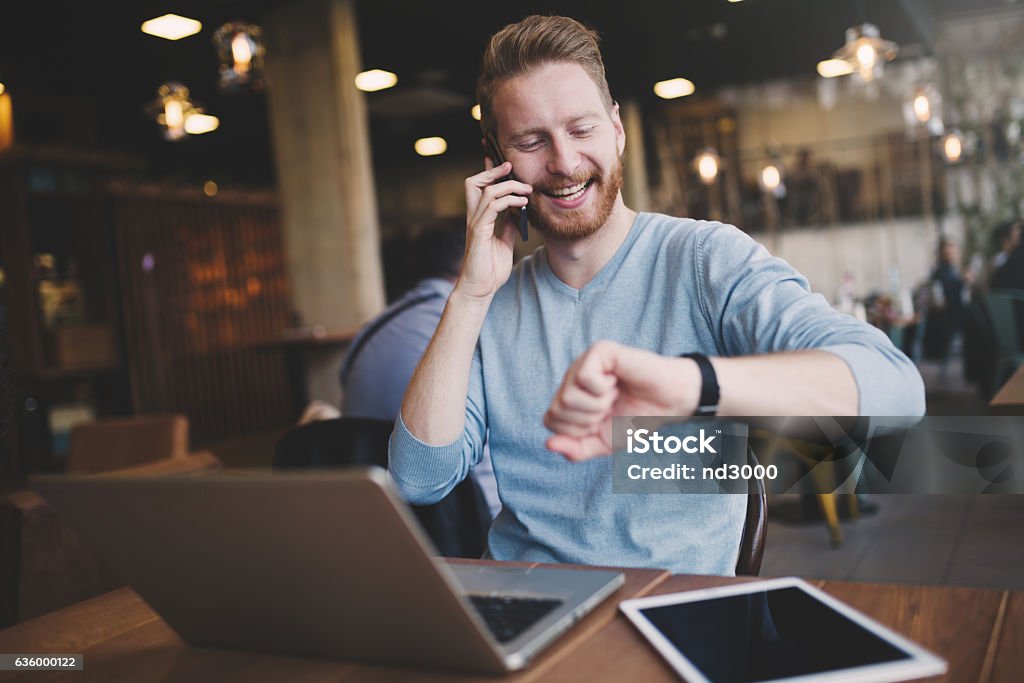 Occupied businessman multitasking in cafe Occupied businessman multitasking in cafe with technology Manager Stock Photo