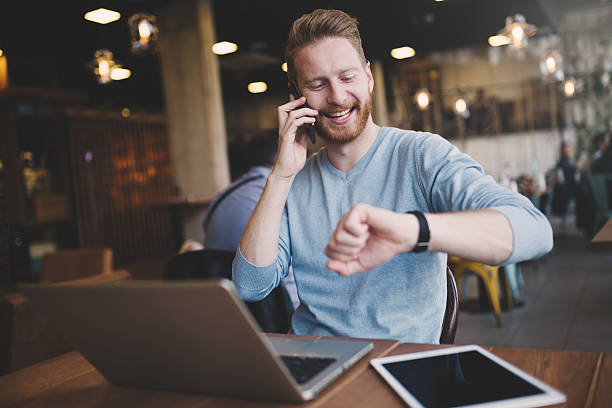 Occupied businessman multitasking in cafe Occupied businessman multitasking in cafe with technology time management student stock pictures, royalty-free photos & images