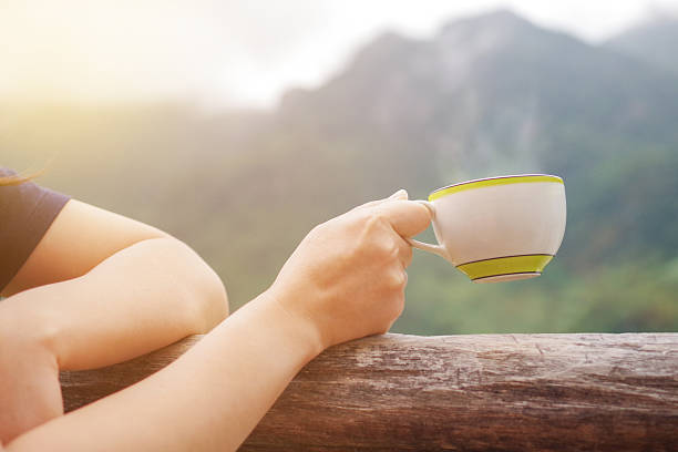 istock Morning hot drink, coffee or tea cup in female hand 636000512