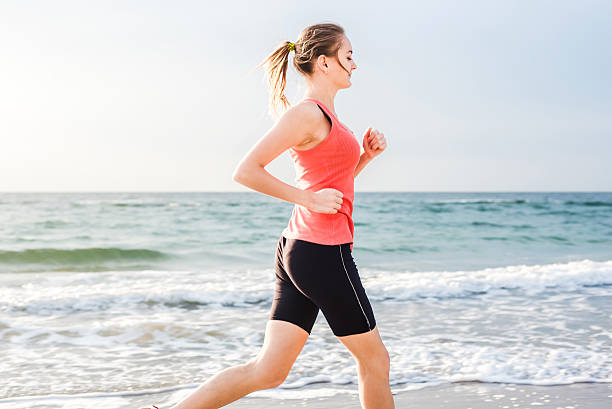 istock Running woman on beach 636001456
