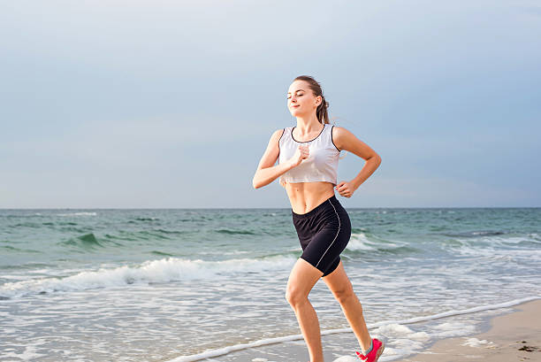 istock Running woman on beach 636001578