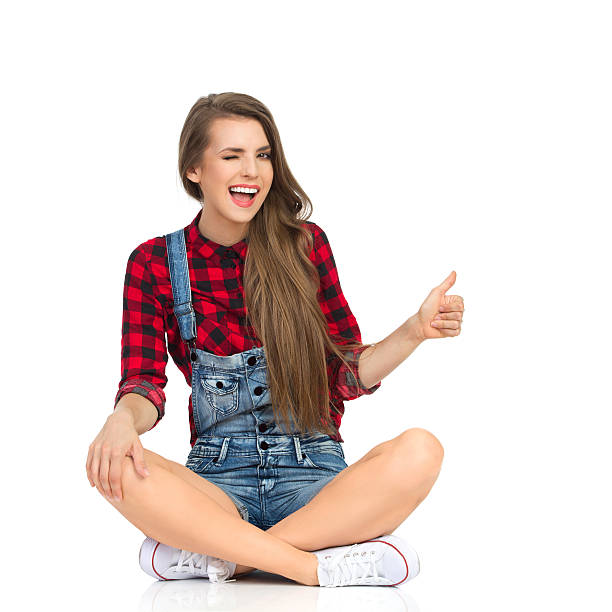 istock Winking Woman Showing Thumb Up 636006694