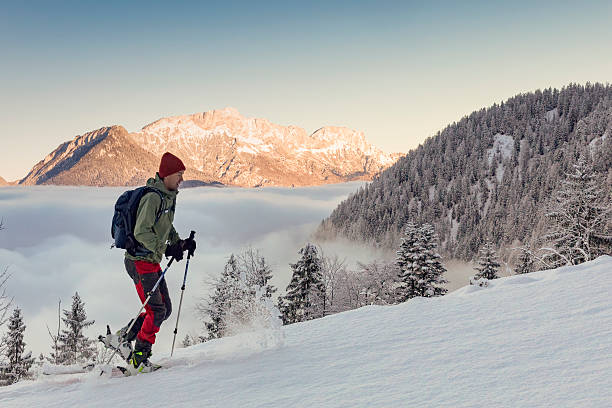 Back country Ski touring in alps with Untersberg in background Skier ascending a mountain in winter in Nationalpark Berchtesgaden with alpen glow at Untersberg in background berchtesgaden national park photos stock pictures, royalty-free photos & images