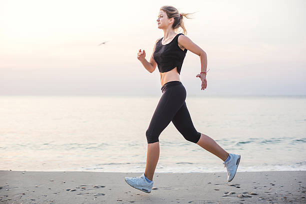 istock Running woman on beach 636008790