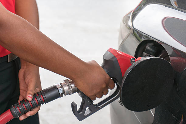 istock Hand refilling the car with fuel 636009612