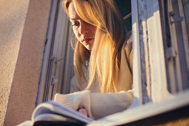 istock Close up woman reading book at morning 636010042