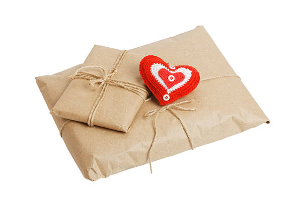 istock Parcels with kraft paper and red heart isolated on white 636010768