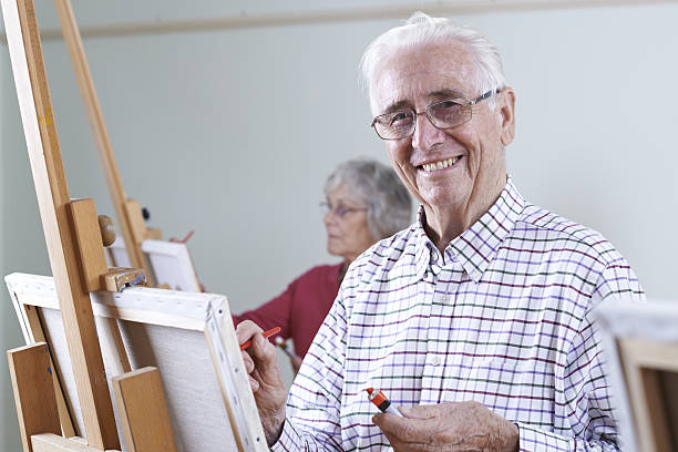 istock Seniors Attending Painting Class Together 636012550