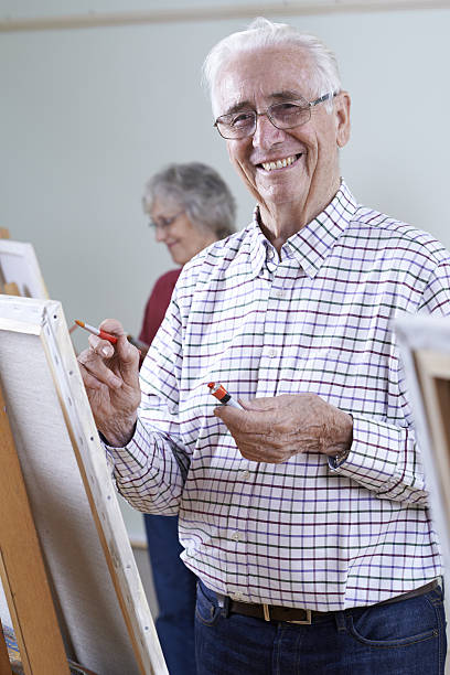 istock Seniors Attending Painting Class Together 636012674