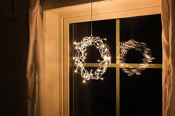 istock christmas decoration lights hanging on window 636014328