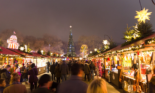 London, England - December 18, 2016: People walking in the Christmas markt of the Hyde Park's winter WonderLand park.