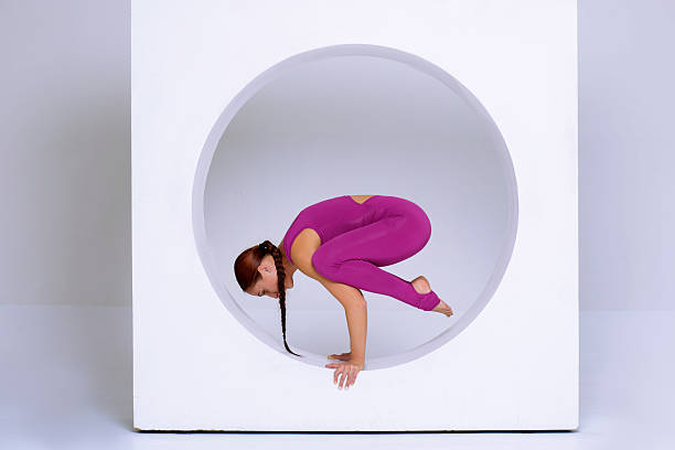 istock athletic woman balancing on hands 636018044