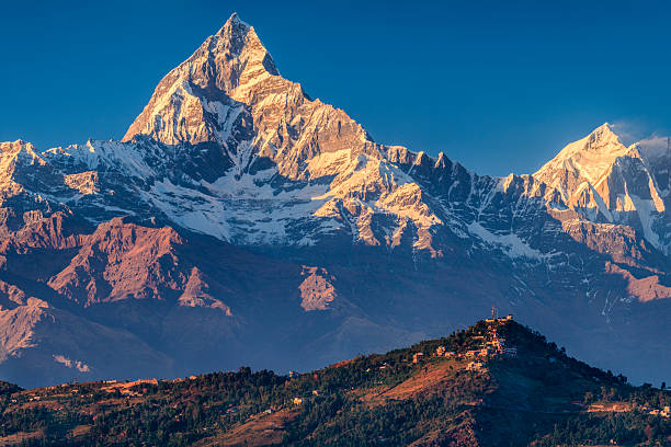 Sunset over Machapuchare seen from Pokhara, Nepal The Annapurna region is in western Nepal where some of the most popular treks (Annapurna Sanctuary Trek, Annapurna Circuit) are located. Peaks in the Annapurnas include 8,091m Annapurna I, Nilgiri and Machhapuchchhre. The Annapurna peaks are among the world's most dangerous mountains to climb,  annapurna circuit photos stock pictures, royalty-free photos & images