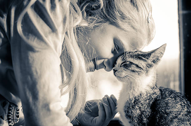 istock happy smiling blond girl with cat 636019336