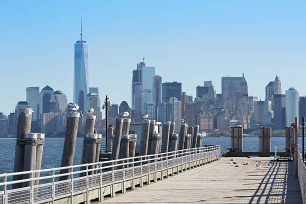 istock New York city skyline and pier with seagulls, sunlight 636021060