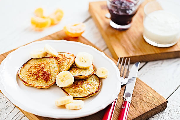 Morning banana pancakes with on white plate and wooden table stock photo