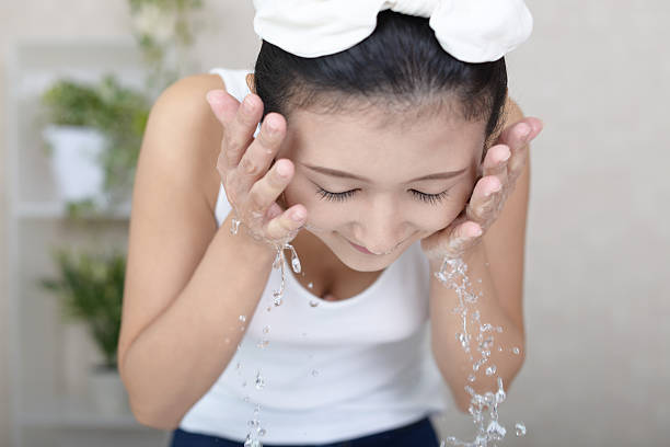 istock Woman washing her face 636022618