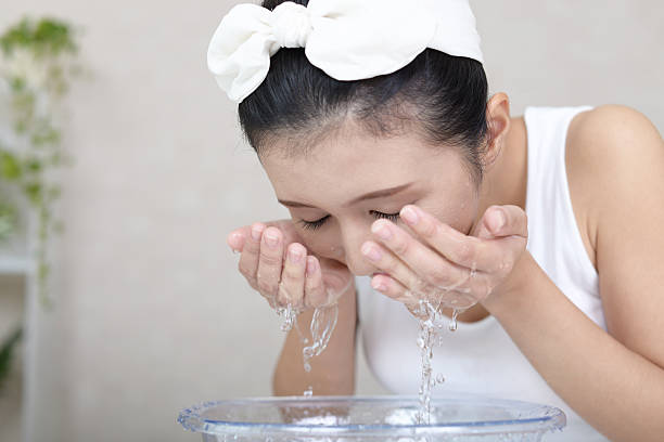 istock Woman washing her face 636025816