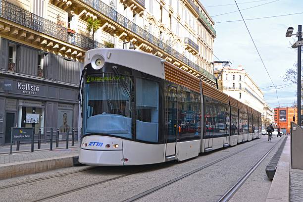 Modern tram in Marseille center Marseille, France - March 25th, 2014: Bombardier Flexity Outlook tram driving in Marseille center. Bombardier manufacture 26 bi-directional Flexity Outlook trams in 2004. Bombardier is one of the largest European train, tram and metro producers. blurred motion street car green stock pictures, royalty-free photos & images