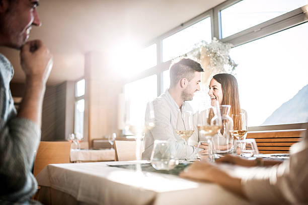 istock Group of Young People Enjoying Dinner at the Restaurant 636028624