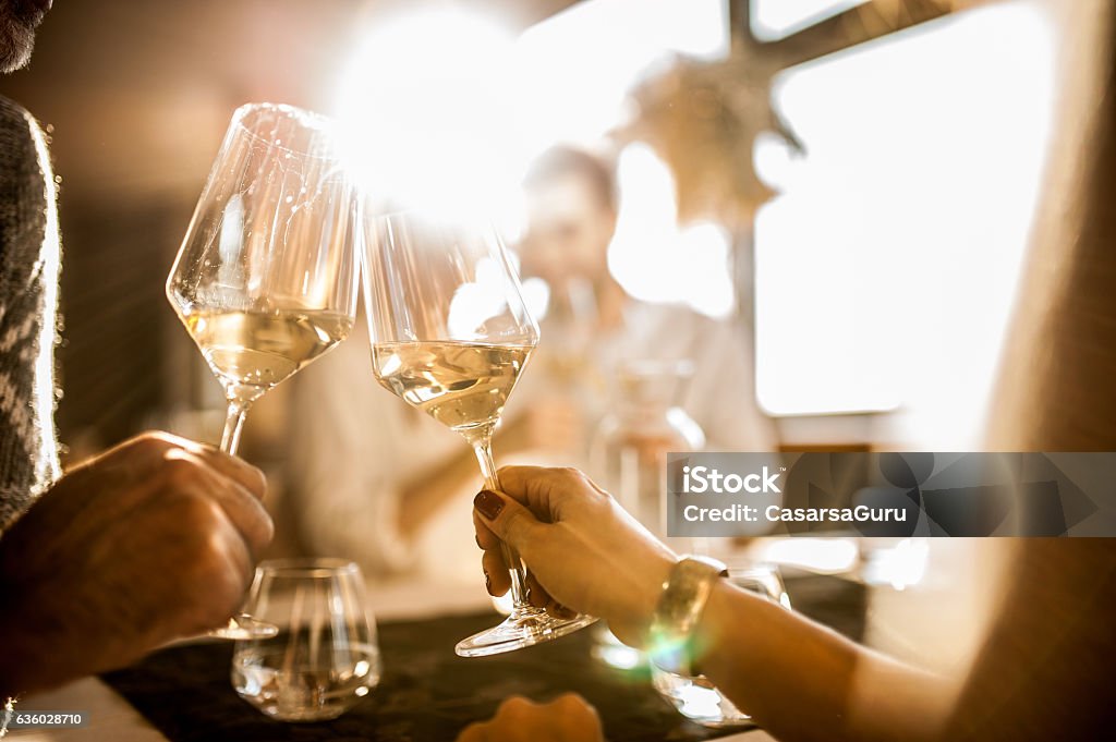 Group of Young People Enjoying Dinner at the Restaurant Wine Stock Photo