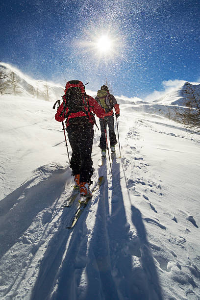 ski mountaineering in snowstorm stock photo