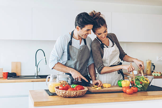 istock Lovely couple making salad 636029656