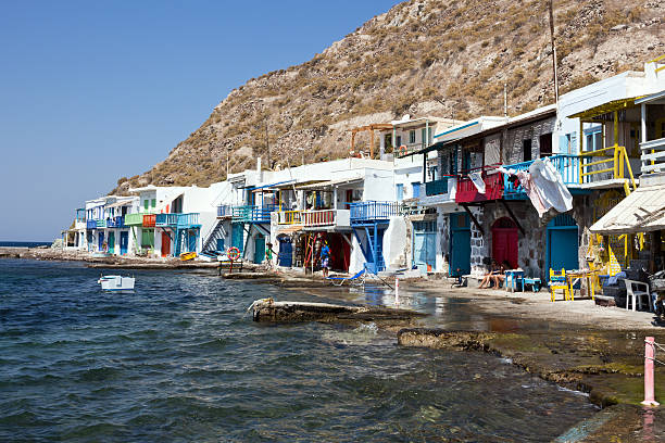Milos, Greece - September 16, 2016: Tourists to be walking around the Klima village. The fishermen houses that are carved into the rocks are known as Syrmata. Cyclades Islands, South Aegean.
