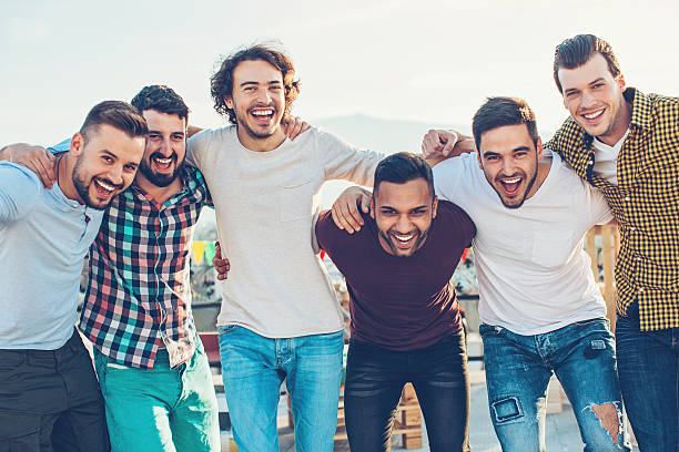 Group of young men Multi-ethnic group of young men holding together and laughing. group of animals stock pictures, royalty-free photos & images