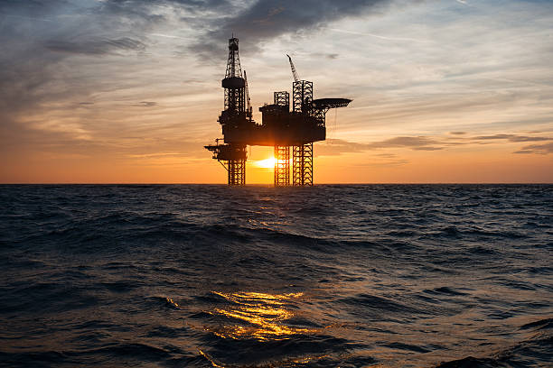 Silhouette of an offshore oil drilling rig stock photo