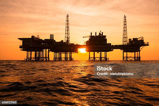 Silhouette Of An Offshore Oil Installation Stock Photo - Download Image Now - Offshore Platform, Drilling Rig, Sea