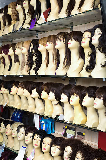 istock Mannequins with colorful wigs types on shelves 636034228