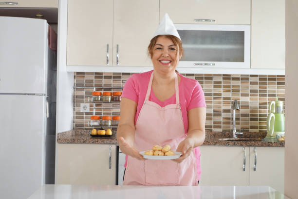 Female chef or housewife presenting cookies