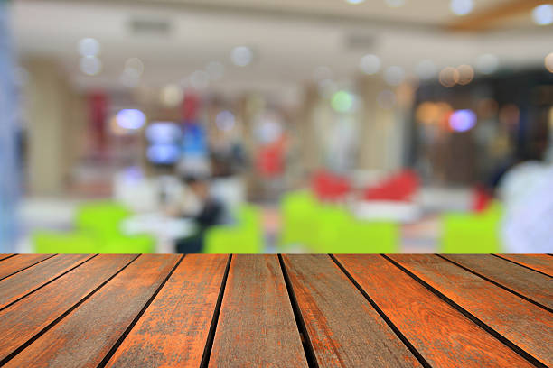 istock wood table and  abstract blurred photo coffee shop background. 636036426