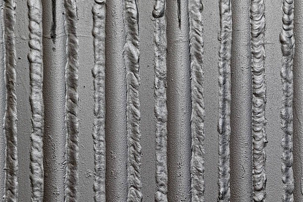 Gray pipes background Metal panel made of rounded steel pipes. Ideal metallurgical weld. deconstruct stock pictures, royalty-free photos & images