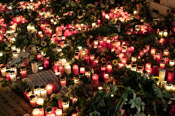 Candles, flowers and condolence messages , Berlin Christmas Market Berlin, Germany - December 20, 2016: Candles, flowers and condolence messages at Christmas Market in Berlin, the day after a truck drove in crowd of people. kaiser wilhelm memorial church stock pictures, royalty-free photos & images