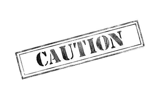 'CAUTION ' rubber stamp over a white background stock photo