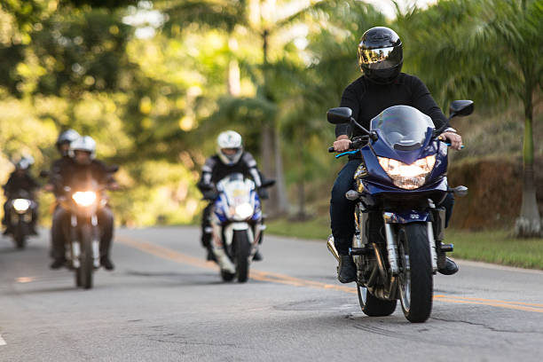 a group of individuals riding along a road