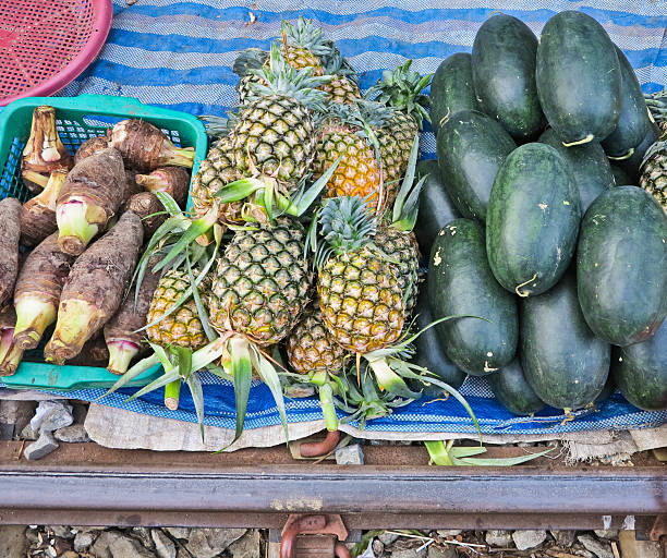 Taro,pineapple and watermelon market in Maeklong Railway Market