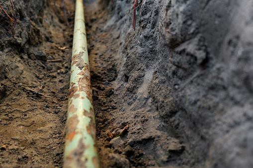 Detail of a residential gas pipe in a trench.
