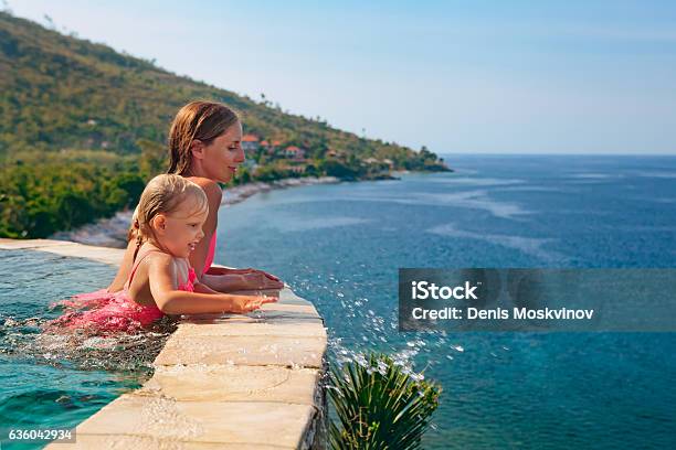 Mother With Child Swim With Fun In Infinity Pool Stock Photo - Download Image Now - Family, Luxury, Tourist Resort