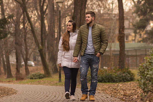 istock Young couple walking winter autumn day 636044630