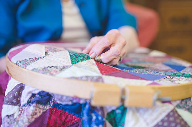 istock Elderly womans hand crocheting a quilt 636044724