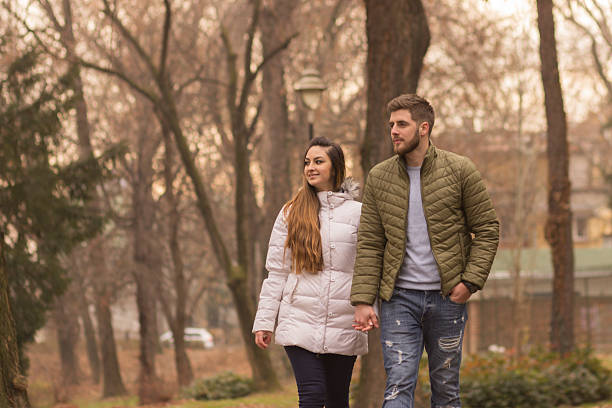 istock Young couple walking winter autumn day 636044884