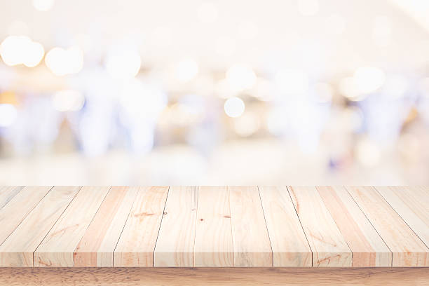 istock Empty top of wooden table with blur shopping mall background. 636047420