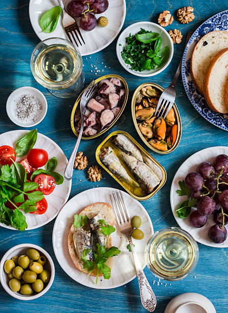 istock Seafood snacks - sardines, mussels, octopus, grape, olives, white wine 636047868