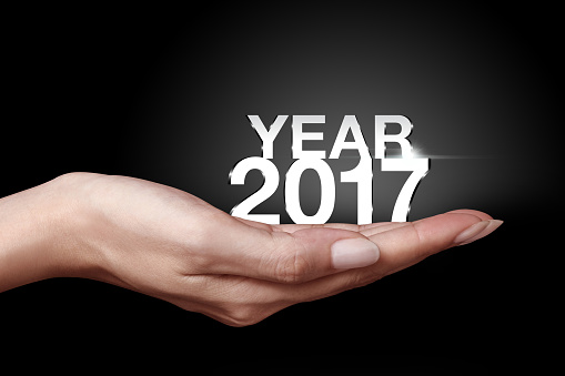 Year 2017 with hand. New year is the first day of the year in the Gregorian calendar..