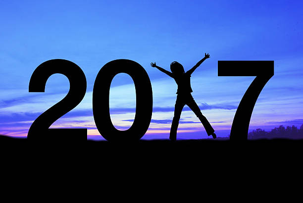 istock Silhouette young woman happy for 2017 new year. 636054998